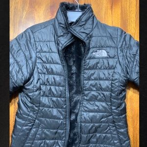 Black reversible fuzzy north face coat.  Like new